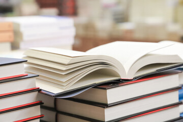 stack of books on the table. open book