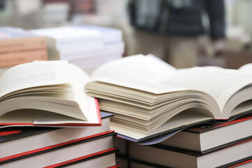stack of books on the table. open book