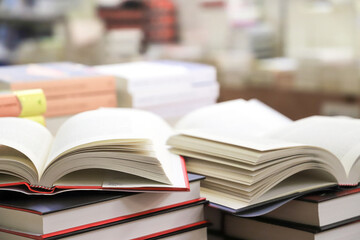 stack of books on the table. open book