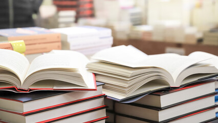 stack of books on the table. open book