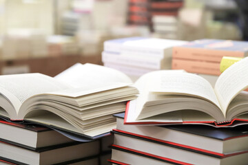 stack of books on the table. open book