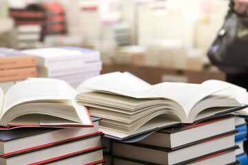 stack of books on the table. open book