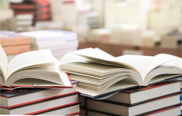 stack of books on the table. open book