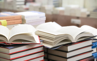 stack of books on the table. open book