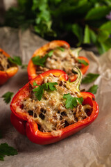 Stuffed peppers with herbs and cheese on the rustic background. Selective focus. Shallow depth of field.