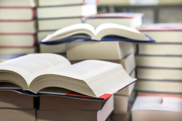 stack of books on the table. open book