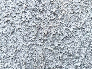 Rough texture of a concrete wall with cracks and irregularities. Gray tones, ideal for urban projects, backgrounds or industrial design. High quality, detail