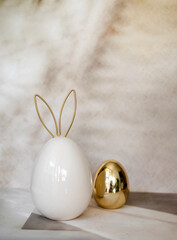 White and gold  ceramic easter eggs on shadows background 