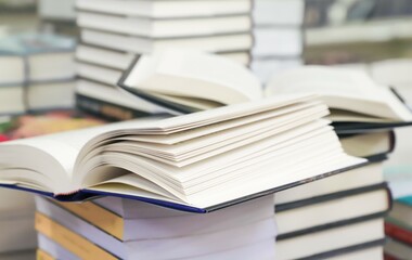 stack of books on the table. open book