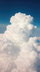 A puffy cumulus cloud rises high above the earth, a white, cotton-like mass, cumulus, puffy