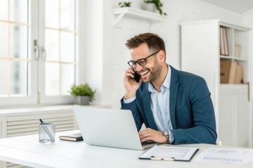 Fototapeta premium Professional Businessman Happily Engaged in a Phone Call While Working on Laptop in Modern Office Space