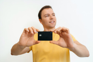 Portrait of a smiling man showing credit card