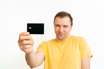 Portrait of a smiling man showing credit card