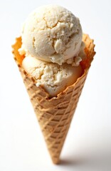 Almond ice cream in waffle cone isolated on white backdrop. Delicious vanilla dessert two scoops refreshment. Sweet gelato snack for summer. Cold creamy dairy product with nut flavor.