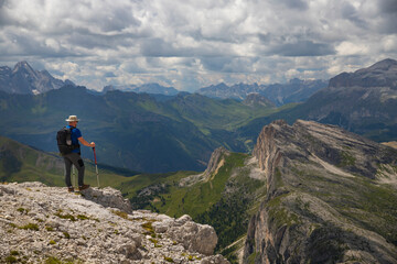 Hiker enjoys the view from Lagazuoi mountain over the italian Dolomites.