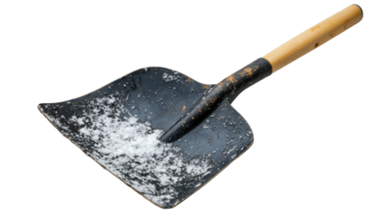 Metal snow shovel with wooden handle resting on a flat surface after winter use in cold weather