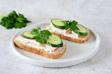 Simple Ham and Cucumber Sandwiches on white plate