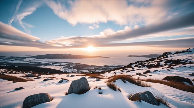 Snow blankets rugged terrain under a serene, vibrant sky.