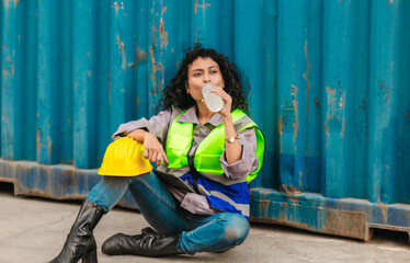 Exhausted Worker Resting at Container Yard.