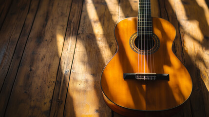 Obraz premium Spanish acoustic guitar centered on wooden floor, evoking timeless musical elegance.