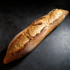 Golden Artisan Bread Texture on Dark Stone Background