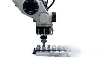 Robotic Precision: A close-up shot of a robotic arm engaged in a manufacturing process, demonstrating high precision and automation in an industrial setting.