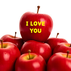 A close-up photo of several fresh red apples against a bright solid white background. On top of the pile of apples, one apple stands out with bright yellow text that reads 'I LOVE YOU
