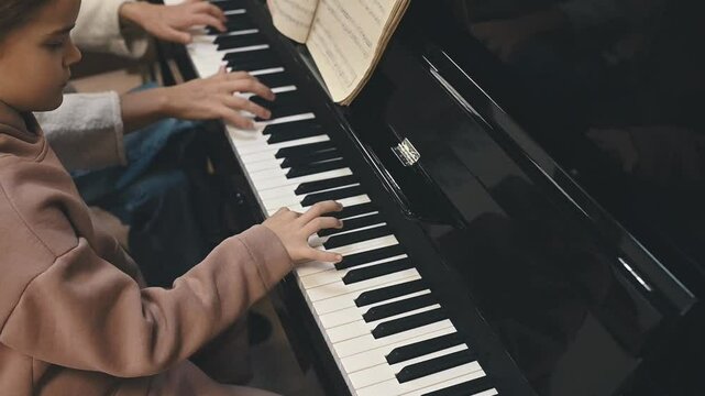  A young girl struggles with piano practice, feeling overwhelmed by learning difficulties. Early frustration in music education can lead to discouragement, requiring strong teacher support