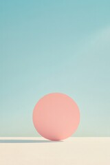 Fototapeta premium Minimalist scene featuring soft pink sphere against tranquil blu