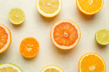 A close up of several oranges and limes on a white background. The oranges are sliced and the limes are whole. Concept of freshness and abundance, as well as the variety of fruits available