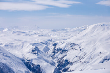 Majestic Snow-Capped Mountains and Vast White Glaciers Stretch as Far as the Eye Can See Against a...