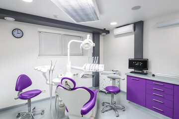 Modern Dental Clinic Interior Featuring Advanced Equipment and Stylish Design with Purple Accents...