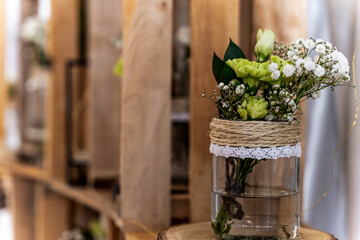 Rustic floral decoration in glass jar at wedding