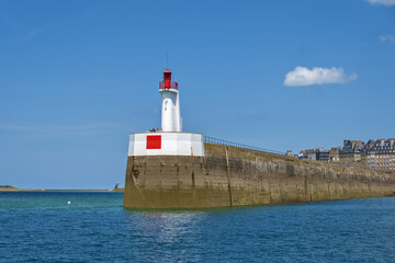 lighthouse at the entrance to the harbor and bulwark and patrician houses of Saint Malo, Brittany, France
