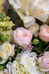 Delicate composition of white and pink roses in a basket