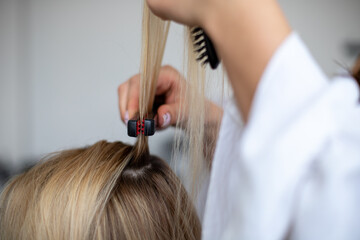 Naklejka premium women hairdresser styles models blonde hair by corrugating them with black and red corrugater