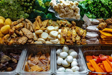 Traditional Asian dishes sold in a food court in Singapore
