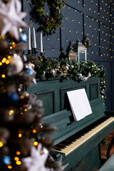 green piano blue wall decorated with christmas tree decor. classic christmas photo zone with piano