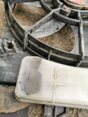 Worn and Damaged Car Cooling Fan and Overflow Reservoir in Engine Bay