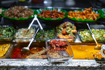 Traditional Asian dishes sold in a food court in Singapore