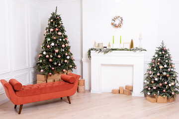 orange sofa next to white fireplace and christmas tree. bronze sofa on light background photo studio