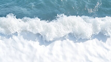 Captivating top view of ocean waves crashing onto shore, creating a serene and dynamic nature scene.