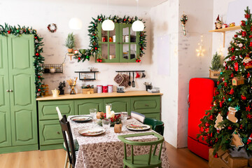 Christmas table with white tablecloth New Year tree green furniture. New Year's kitchen photo zone