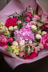 Delicate composition of white and pink roses in a basket