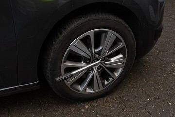 A man demonstrates how to replace a flat tire. Emergency car repair service concept. Flat tire repair. Help anytime, anywhere.