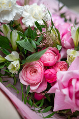 Delicate composition of white and pink roses in a basket