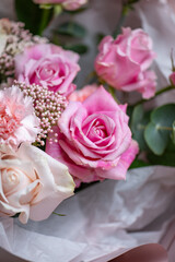 Delicate composition of white and pink roses in a basket