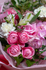 Delicate composition of white and pink roses in a basket