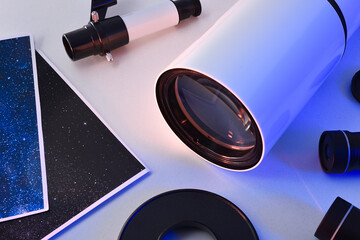 Detail of telescope and photos illuminated with blue light