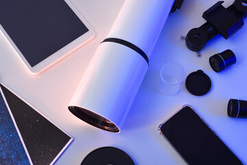 Detail of telescope and partas and electronic devices on table